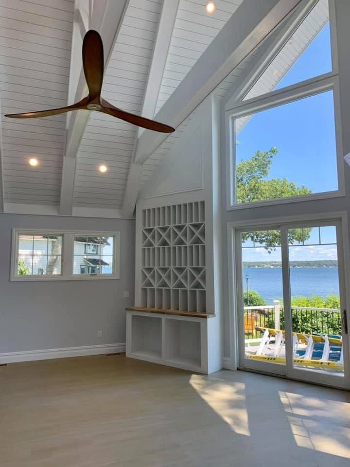Interior painting — lakefront living room with cathedral ceiling and water view, Thousand Islands NY