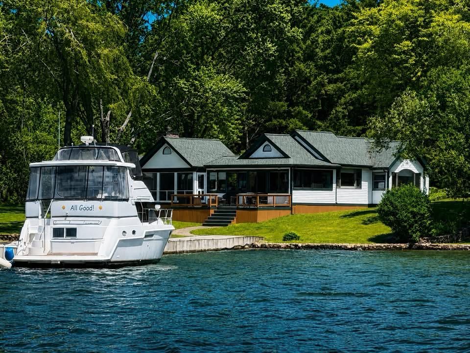 Exterior painting — lakefront cottage with private dock and yacht, Thousand Islands NY